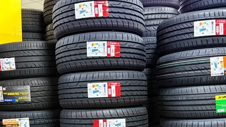 Stacks of new tyres with EU tyre labels on the tread